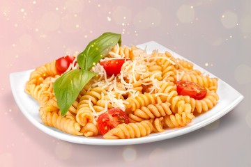 A baked dish of fusilli or pasta spirals, with cherry tomatoes, ricotta and parmesan