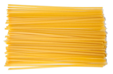 Raw pasta tagliatelle, spaghetti, isolated on white background. Top view.