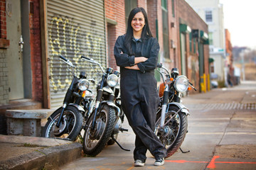 Female mechanic next to motorcycles © Cavan for Adobe