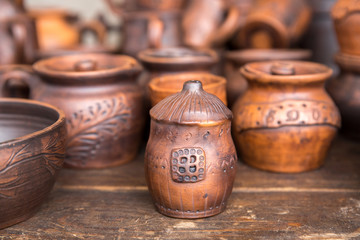 Pottery: pots and cups at the exhibition. The concept of the fair, handmade art and craft.
