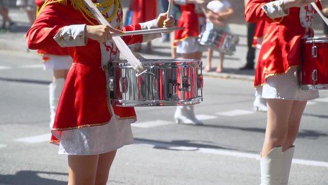 Close-up of female hands drummers are knocking in the drum of their sticks. Slow motion