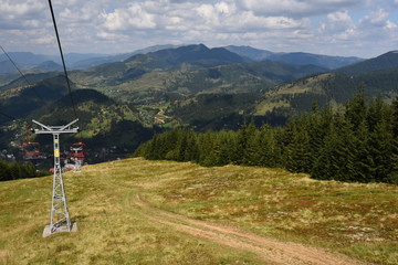 Travel ride with a chairlift in the Carpathian Mountains (Romania).