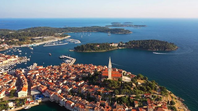 4K. Flight over beautiful Rovinj at sunset. Evening aerial panoramic view of the old town of Rovinj and islands, Istria, Croatia.