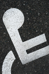 no parking sign painted on asphalt