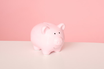 Pink piggybank isolated on pink background.