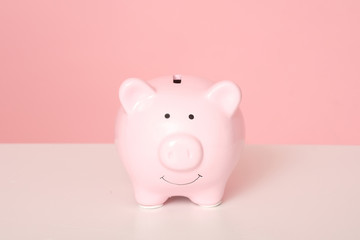 Pink piggybank isolated on pink background.