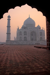 Fototapeta na wymiar Taj Mahal at sunrise framed with the arch of the mosque, Agra, Uttar Pradesh, India