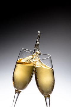 Toasting Champagne Flutes on Grey Background
