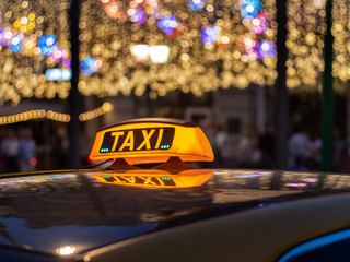 Taxi is waiting for the clients in the city center at Christmas