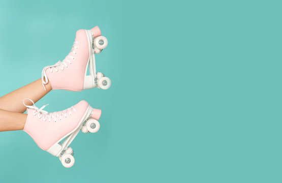 Pink roller skates on the legs. Activity can be fun!