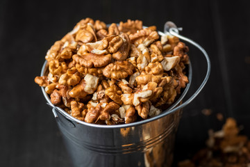 shelled walnuts in a metal bucket