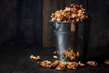 shelled walnuts in a metal bucket
