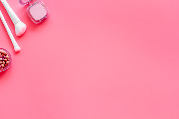 Obraz na płótnie Canvas Brushes for make up, blusher on pink visagiste work desk background top view copyspace