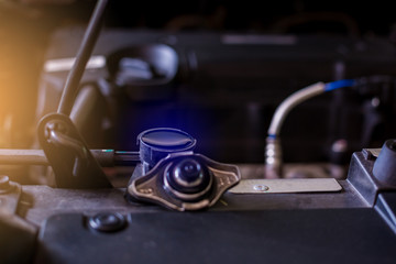 Water full in car radiator, mechanic check water in car radiator, service and maintenance of cars or vehicles, selective focus.