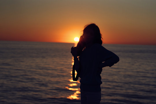 silhouette of woman at sunset