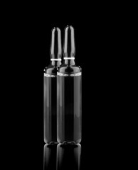 Medical ampoules with solution isolated on black background.