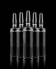 Medical ampoules with solution isolated on black background.