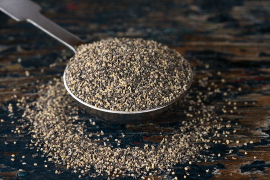 Ground Black Pepper Spilled from a Teaspoon