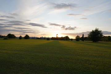 Fototapeta premium fresh green sunset landscape with blue sky and clouds