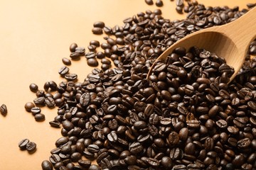 Coffee beans and wooden spoon on a table