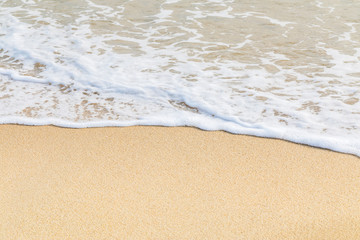 Naklejka na ściany i meble Soft wave of ocean on the sandy beach 
