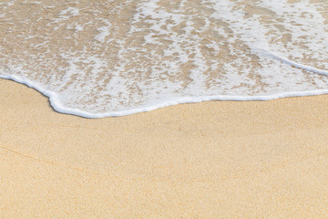 Fototapeta na wymiar Soft wave of ocean on the sandy beach 