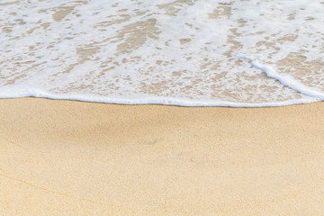 Fototapeta na wymiar Soft wave of ocean on the sandy beach 