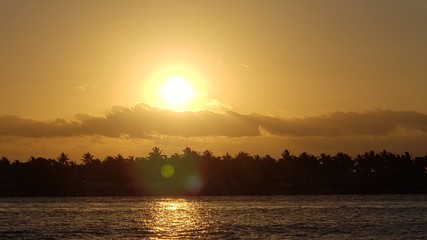 Key West Sunset reflection on water behind clouds