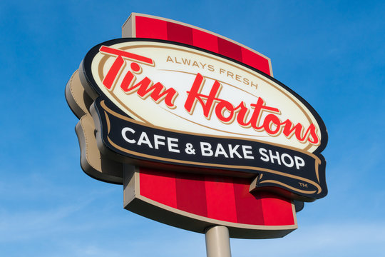 MONTREAL, CANADA - NOVEMBER 6, 2018: Tim Hortons Logo In Front Of One Of  Their Restaurants In Quebec With Their Slogan In French In The Background. Tim  Hortons Is A Cafe And