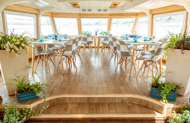 The interior of the urban river ship, with a panoramic view of the urban landscape. The concept of tourism, recreation, walking around the city, rest in the city. River transport.