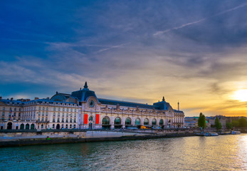 Paris, France - April 21, 2019 - A view of the Musee d'Orsay along the River Seine at sunset in Paris, France.