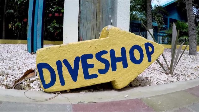 A direction sign of dive shop
