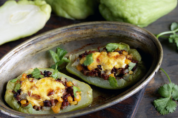 chayote stuffed baked stuffed with minced meat, corn and pieces of the chayot with cheese sauce