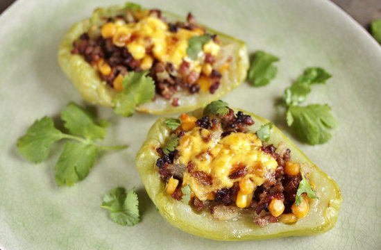 chayote stuffed baked stuffed with minced meat, corn and pieces of the chayot with cheese sauce