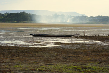 water level in the lake  was low ,fisherman have to leave boat behind.