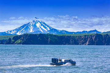 The Hovercraft on Pasific ocean in kamchatka Peninsula on the background volcano
