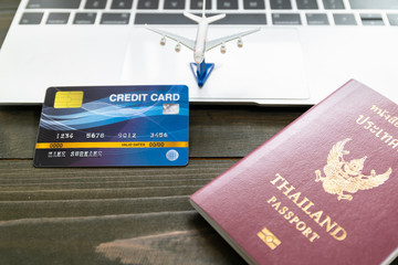 Passport with  credit card on laptop