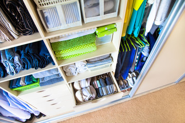Wardrobe with women's and men's clothing. Drawers with underwear, bed linen, socks and shirts.