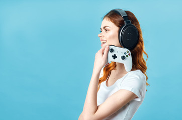 Fototapeta premium girl in headphones holding remote controller