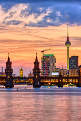 Beautiful sunset at the Oberbaum Bridge in Berlin with the famous Television Tower in the back