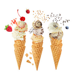 Variety of ice cream scoops in cones with chocolate, vanilla and strawberry