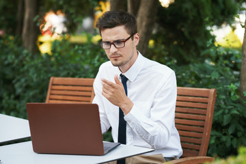 businessman sitting on bench in the park