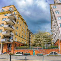 Modern apartment buildings with a green yard in Stockholm, Sweden. Vertical panorama from several shots with fisheye effect.