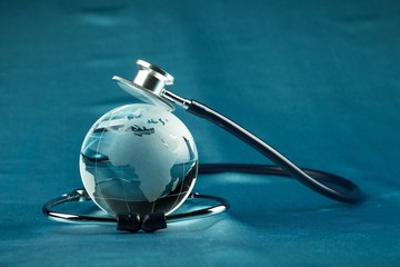 Naklejka na ściany i meble glass globe with a stethoscope