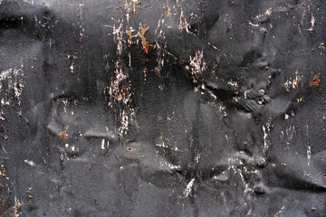 black crumpled metal sheet. Background black bent metal. Black paint on a curved sheet metal.