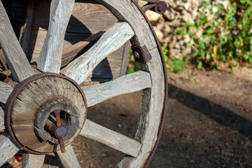 Wooden wheel upholstered with an iron hoop. Close-up, side view.