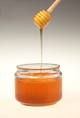 Honey Dripping Into Jar