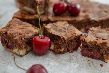 Chocolate brownie pieces decorated with cherry