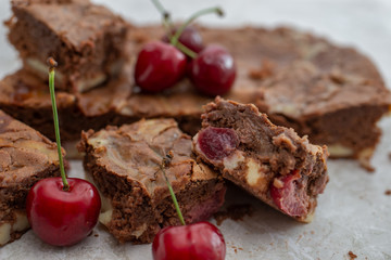 Chocolate brownie pieces decorated with cherry