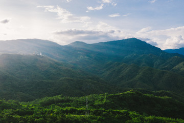 Fototapeta premium Aerial view of mountains and chewed roads on the mountain during sunset at Khao Kho Viewpoint, Phetchabun Province, Thailand